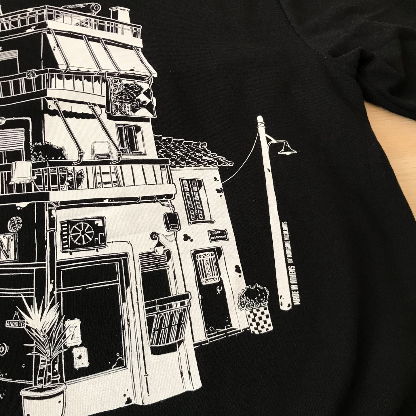 close up of the back design (right part) where details such as the little house stuck to the buildig, a street lamp, balconies, hanging blankets, basilico in traditional olive oil can.
