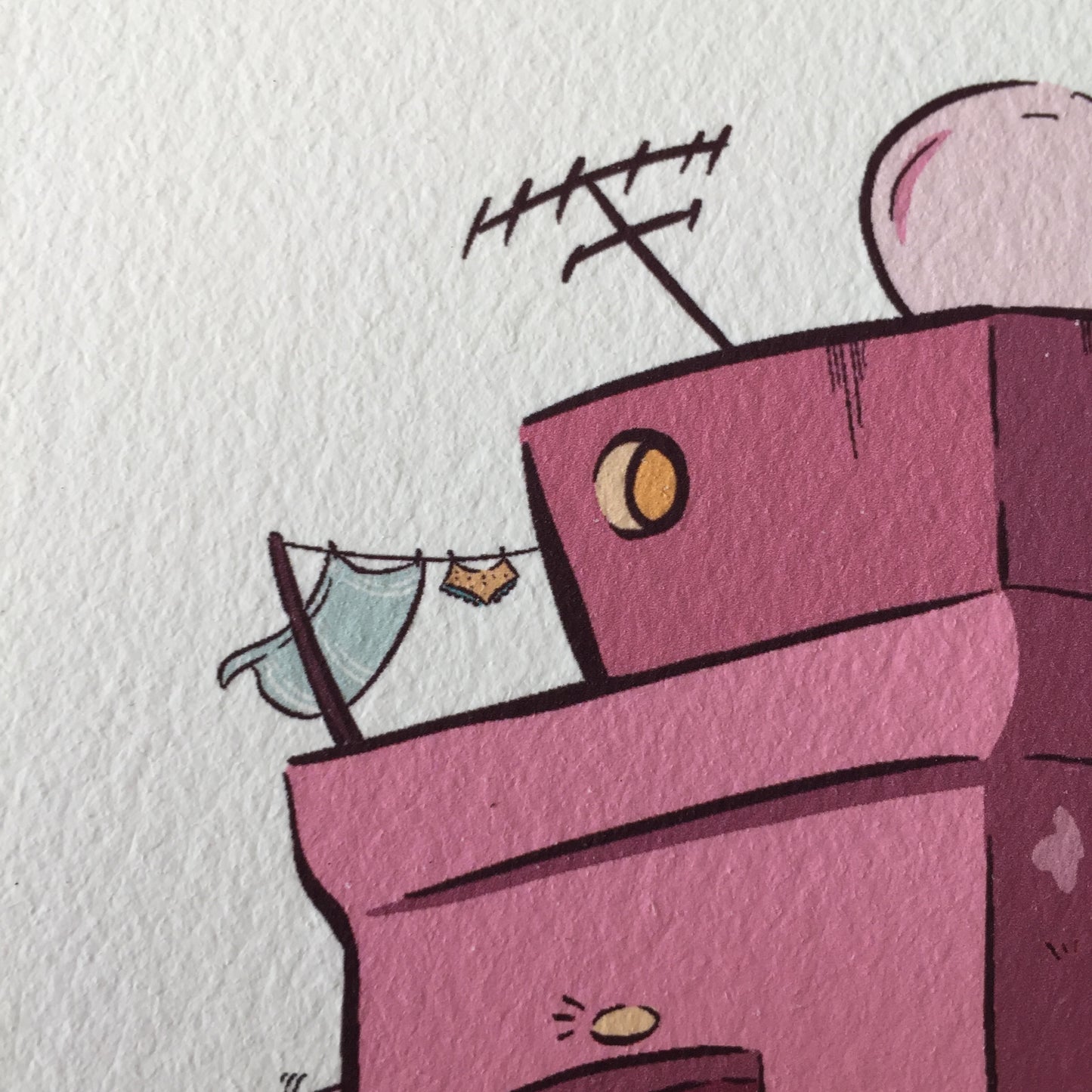 Close up of the top left corner of the building, where we can see a small round window where some light is coming out of it.