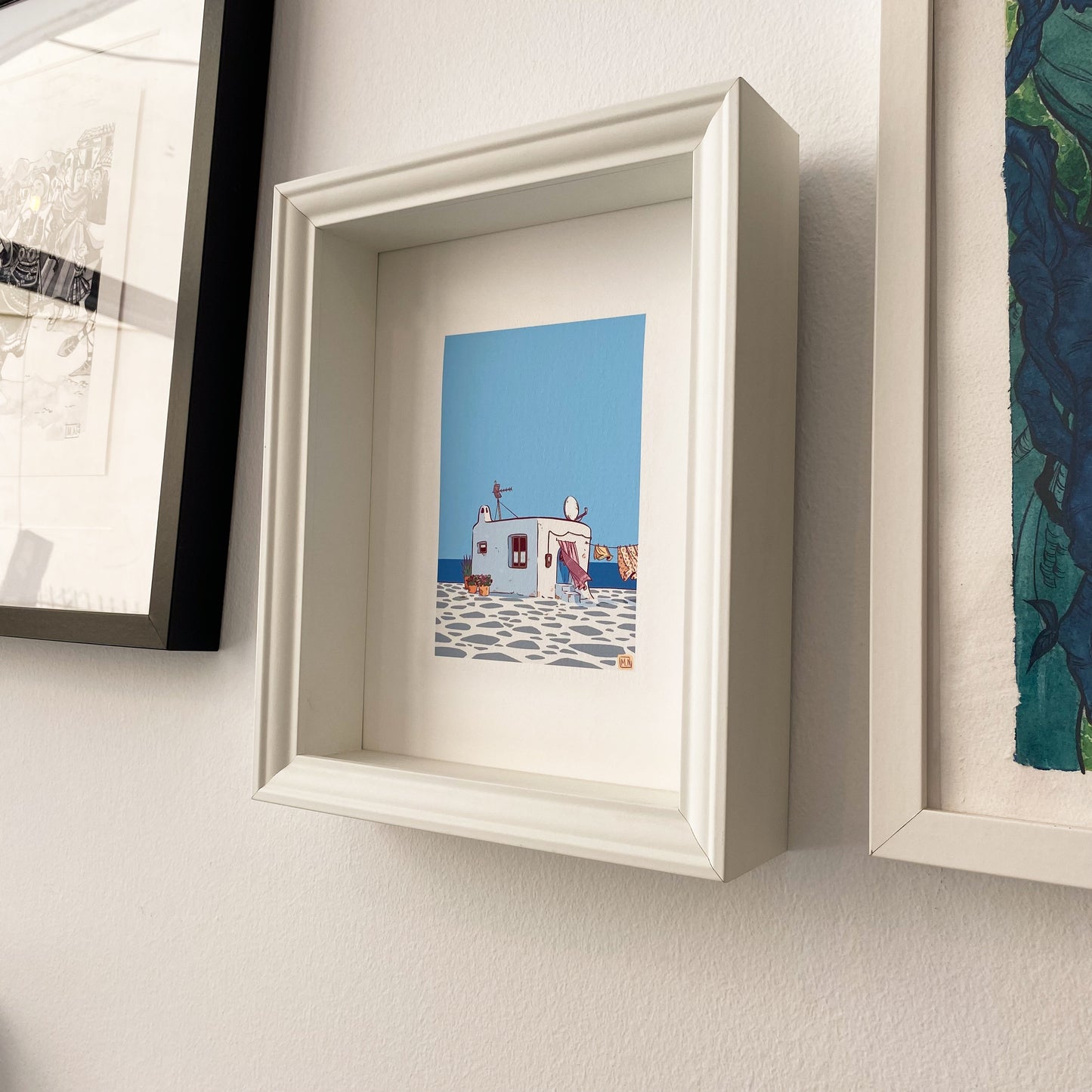The illustration with a white frame hung on a wall.