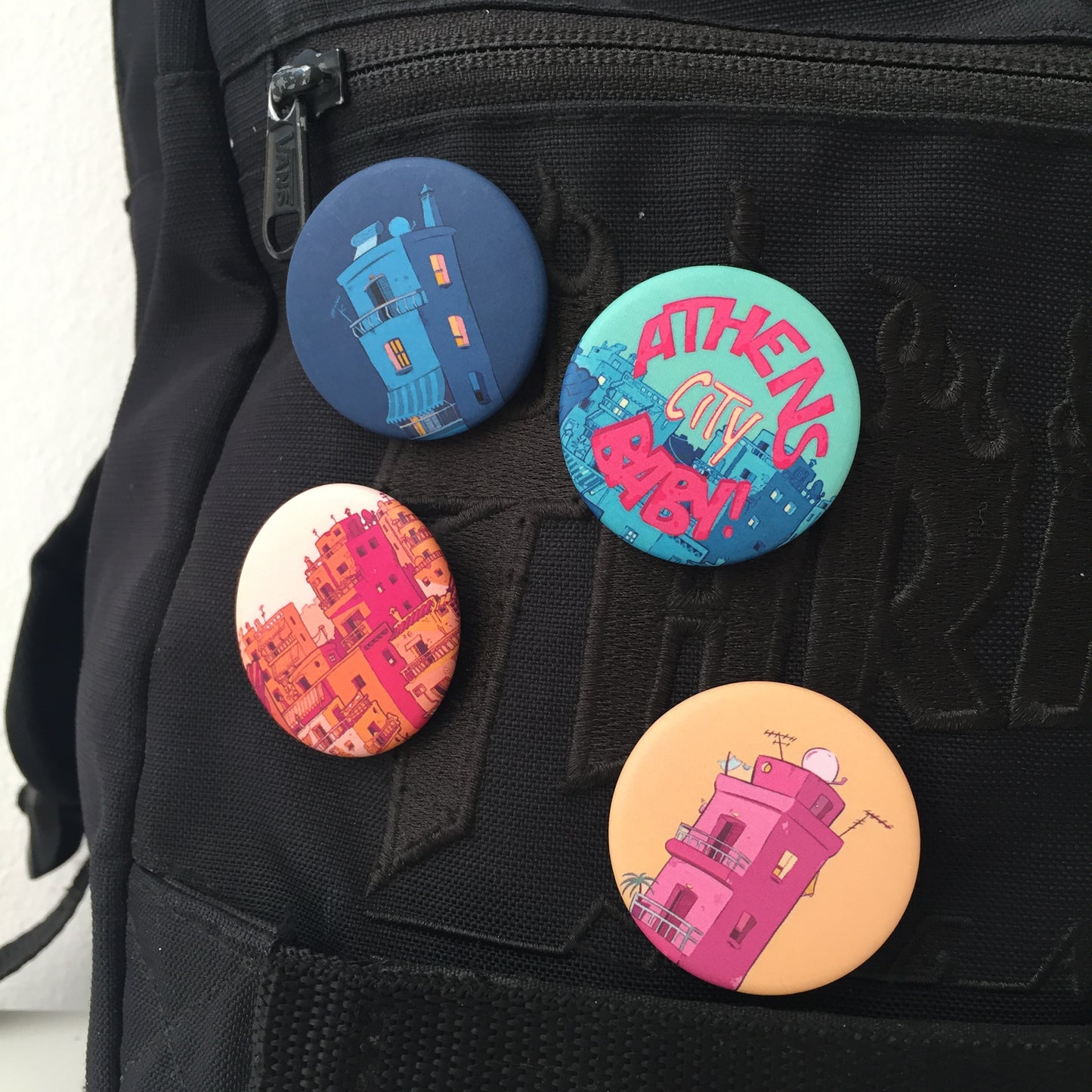 4 pins pinned on a back-pack