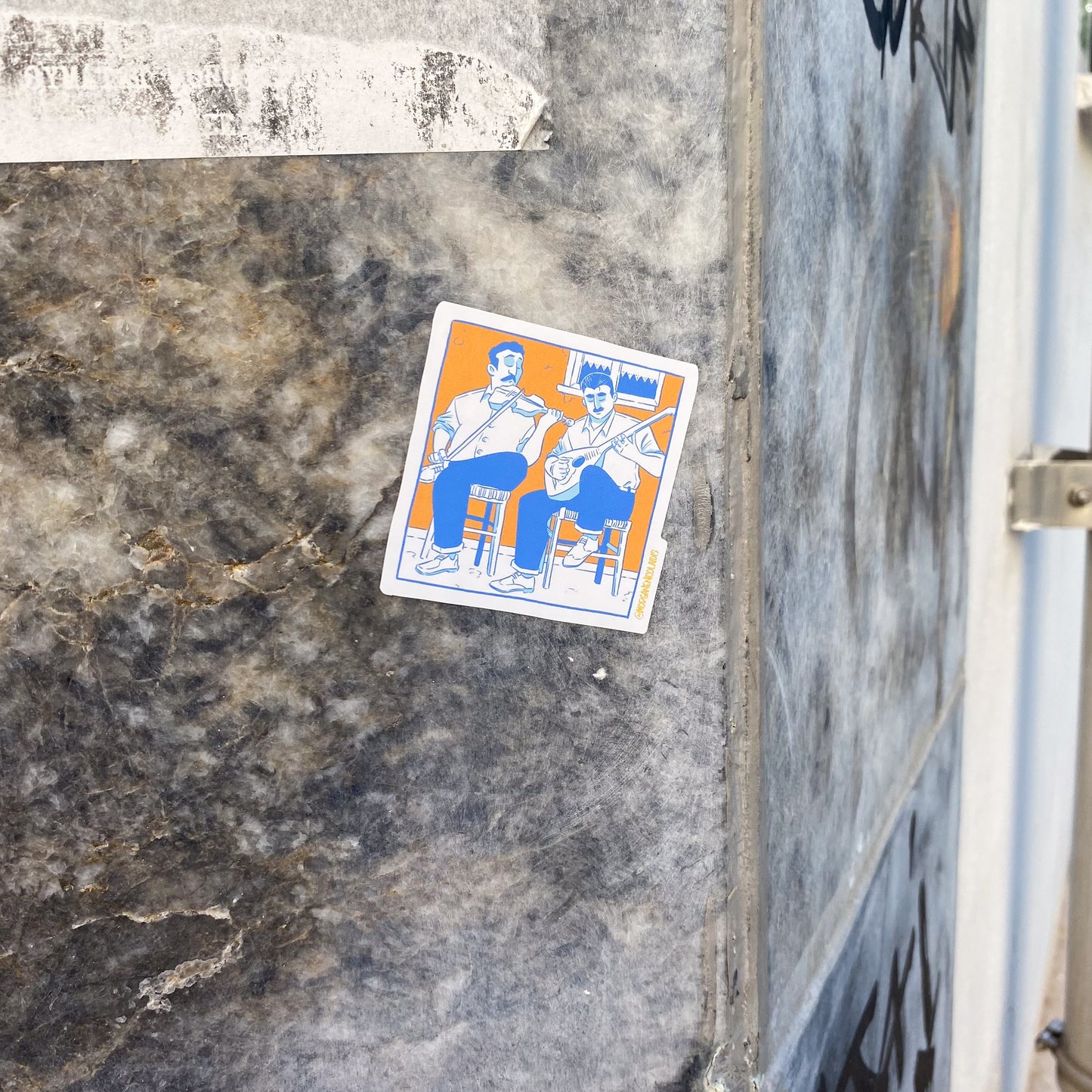 The sticker is stuck on a marble wall.