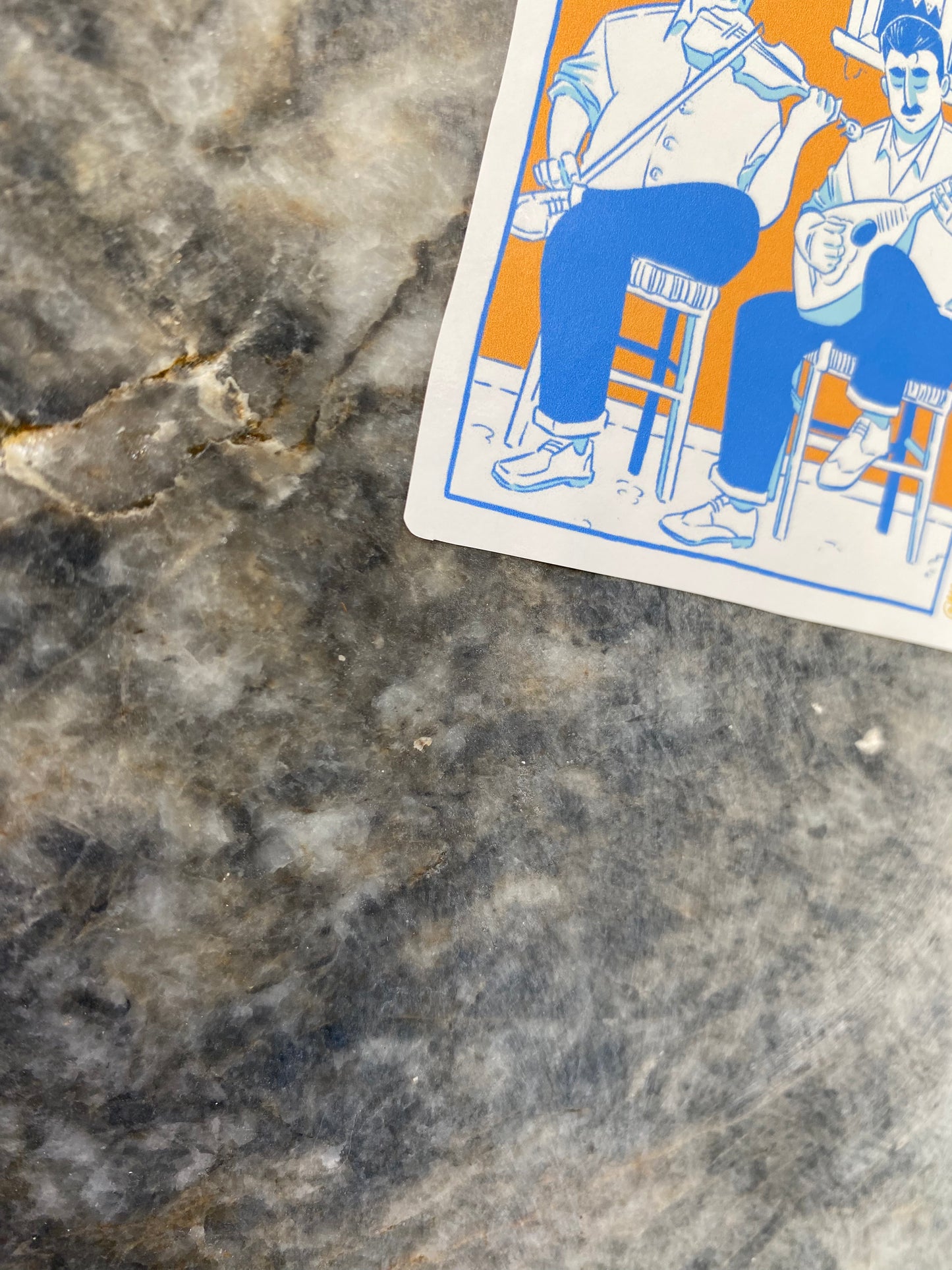 Close up of the left corner of the sticker. Stuck on the marble wall.