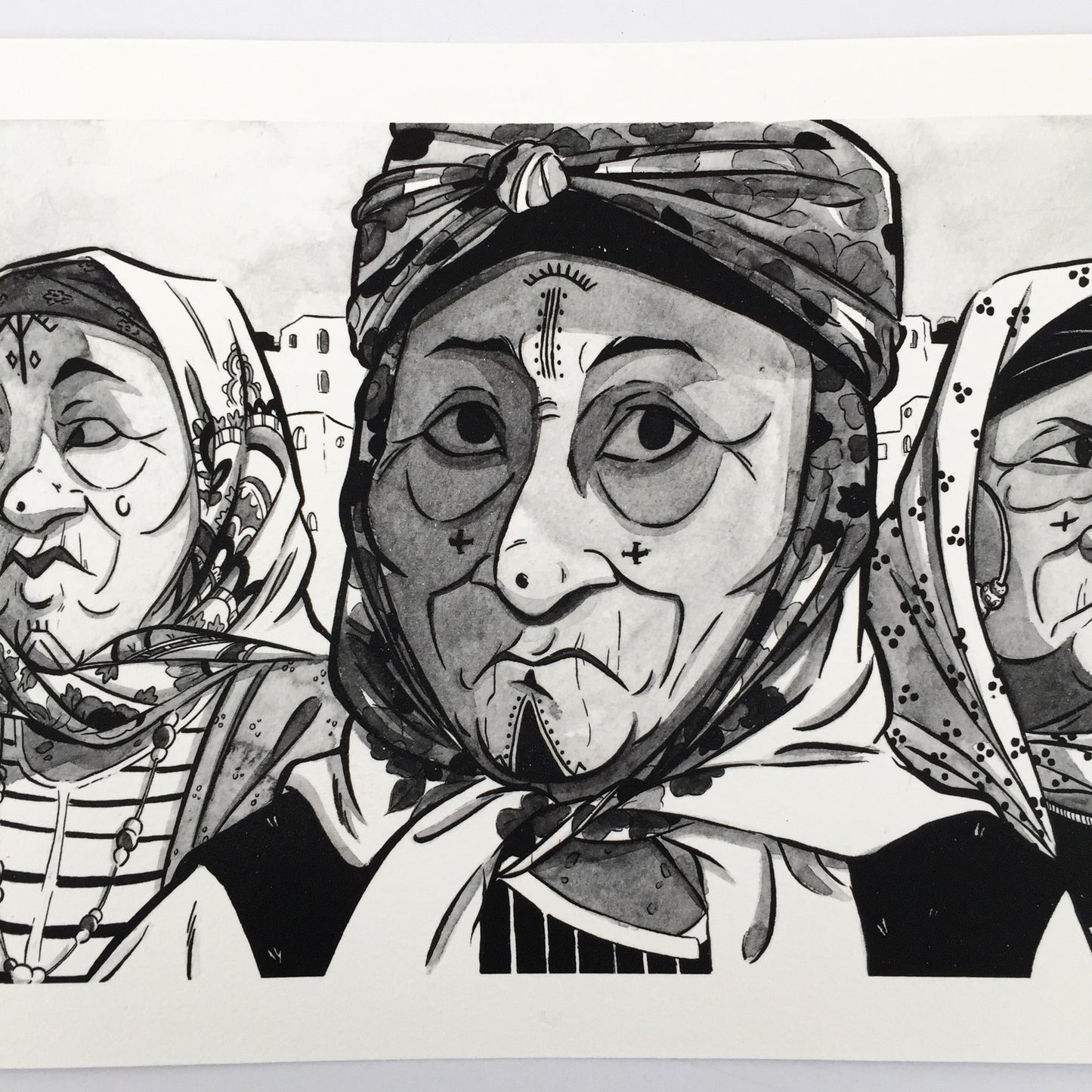 Close up of the lady in the middle of the art work. We can see that she's wearing a traditionnal headscarf and traditionnal tattoos on her cheek, forehead and chin.s