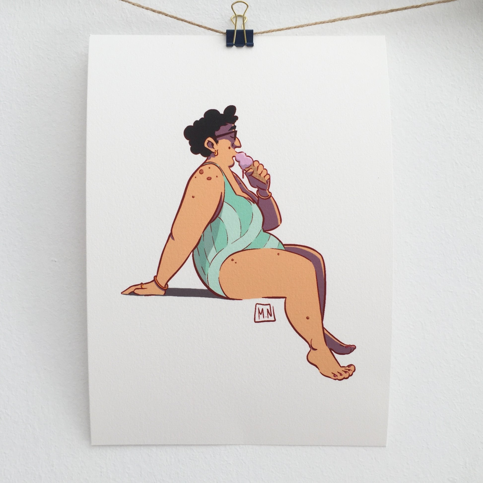 THe art print is hung on a wire with a drawing pliers.