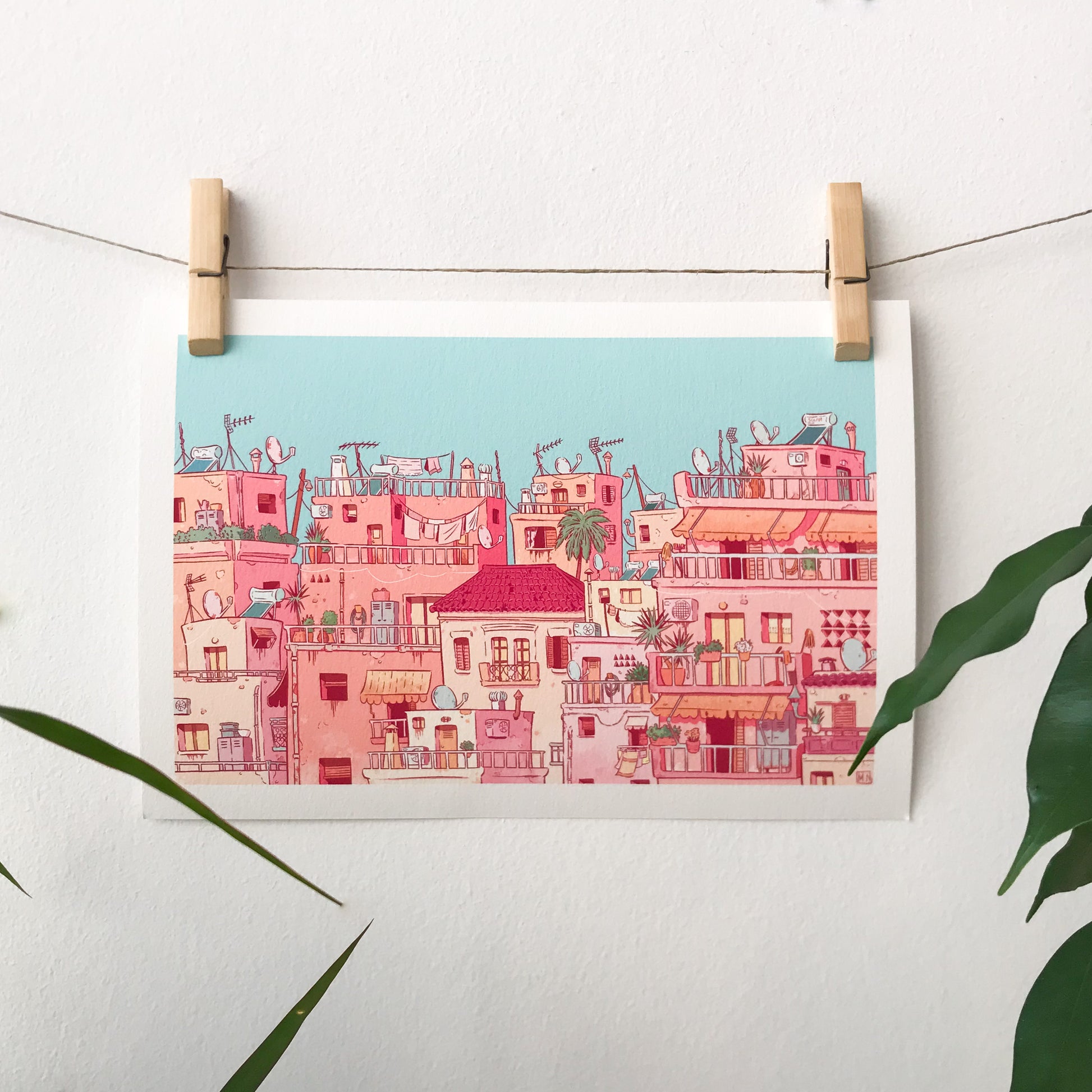 The illustration is hanging on a wire with 2 clothespin.