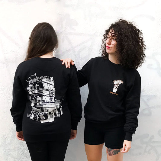 two ladies wearing the sweatshirts. one is showing us the back design and the other one is showing the front one.