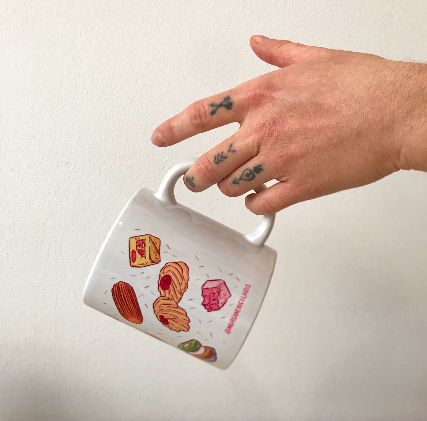 a hand holding one of the mug.