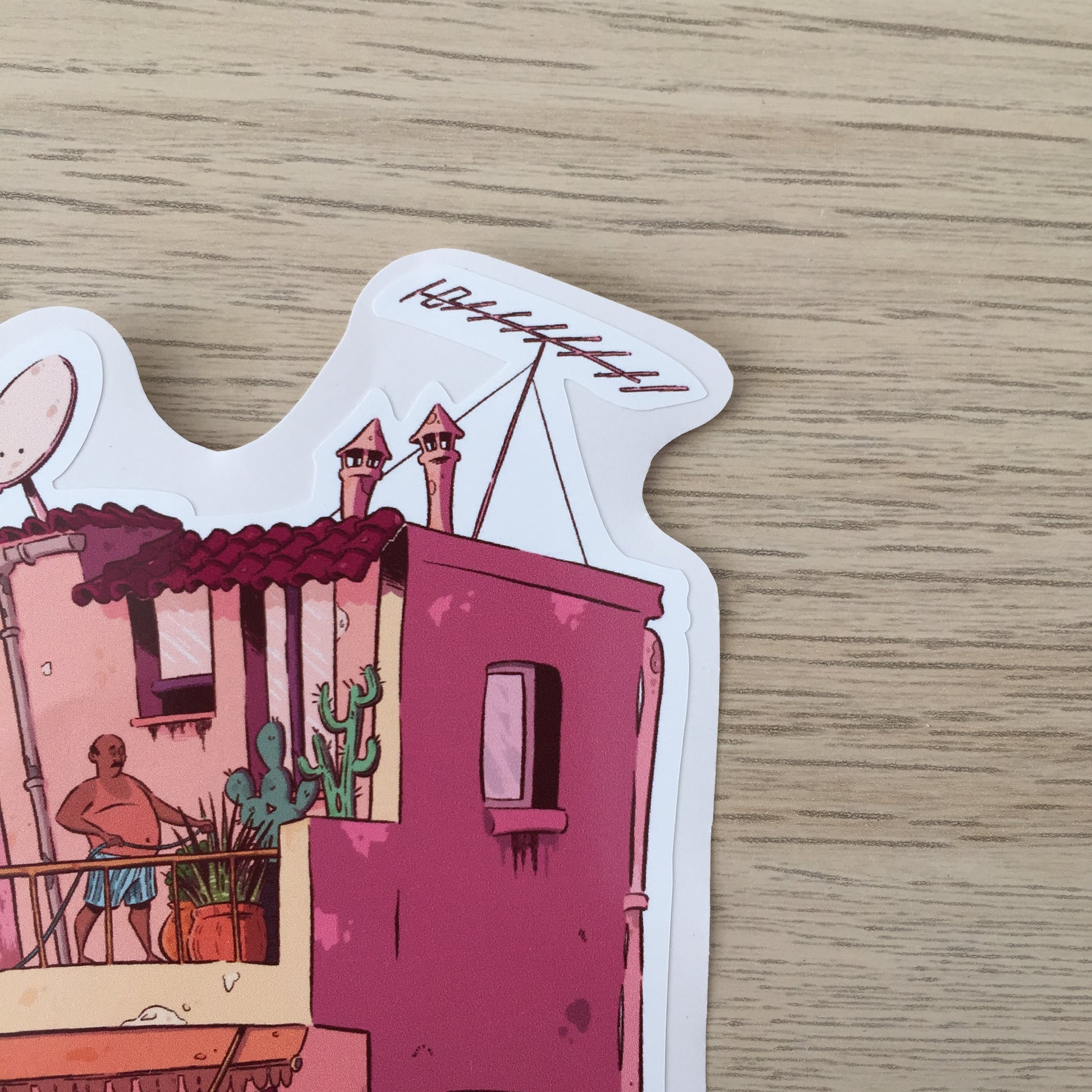 Close up of the top right corner. We have two chimneys, a antenna, a few cactus and a man watering them.