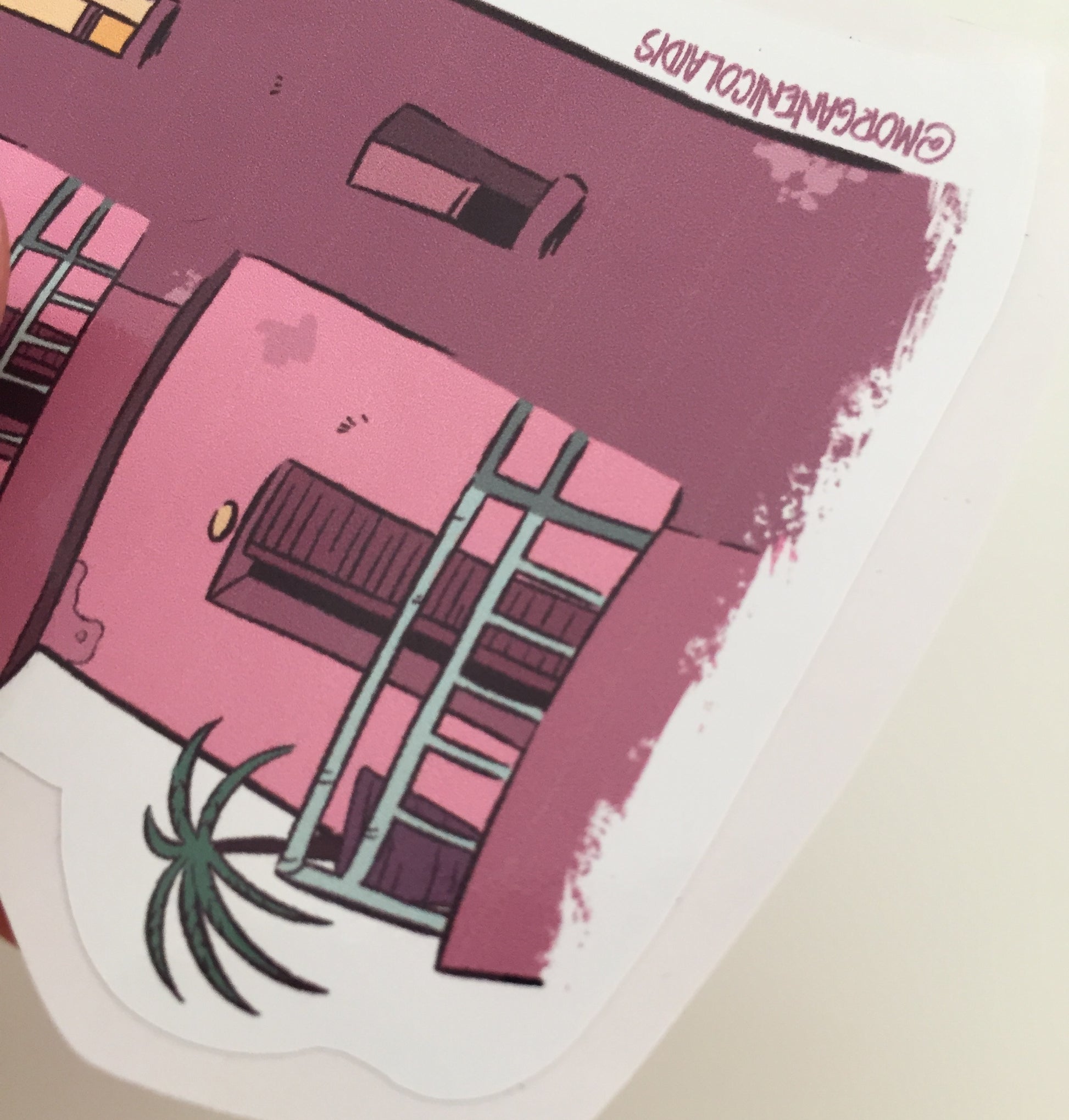 Close up of the bottom of the sticker where the artist signature is visible.